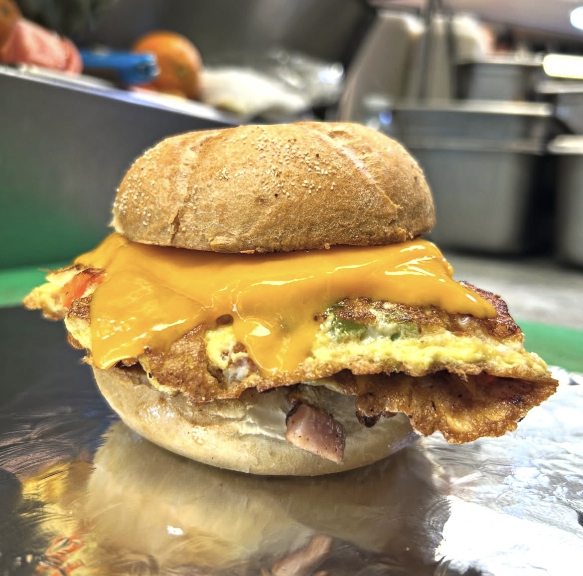 Breakfast sandwich with egg, bacon, and melted cheese